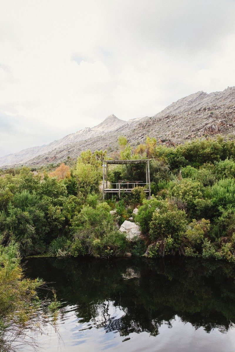 Meditation spot or bird hide overlooking a natural swimming pool in a river