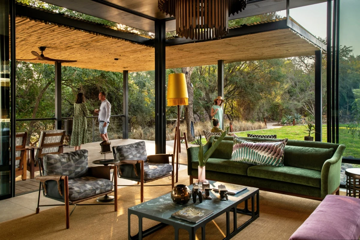 Open-plan lounge at Tanda Tula Safari Camp, Timbavati, where glass-box interiors flow naturally into the Greater Kruger bush