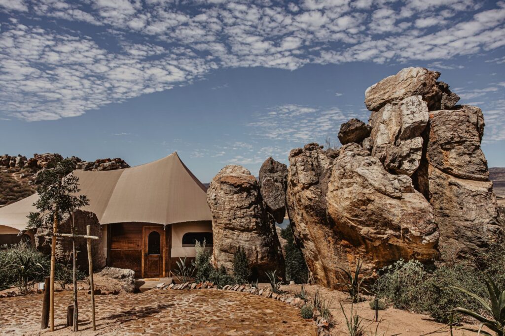 An off-grid luxury tent at Yamu Lifestyle Resort on Clanwilliam Dam in the Cederberg, framed by indigenous fynbos.