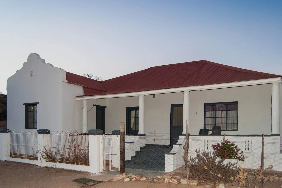 Blue farmhouse with a stoep and painted facade at Nigramoep, a Namaqualand guest farm near Bulletrap