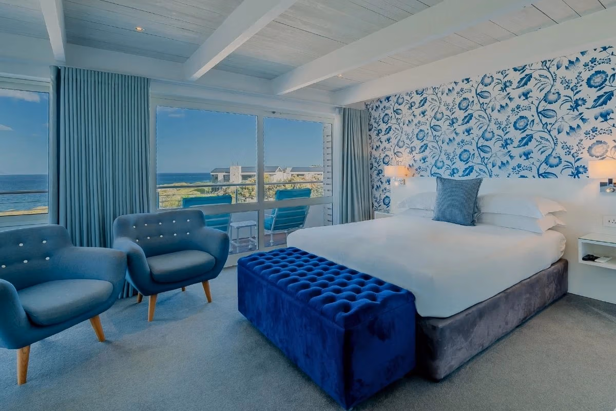 Sea-facing room at One Marine Drive Boutique Hotel with blue-and-white patterned wall and Walker Bay views