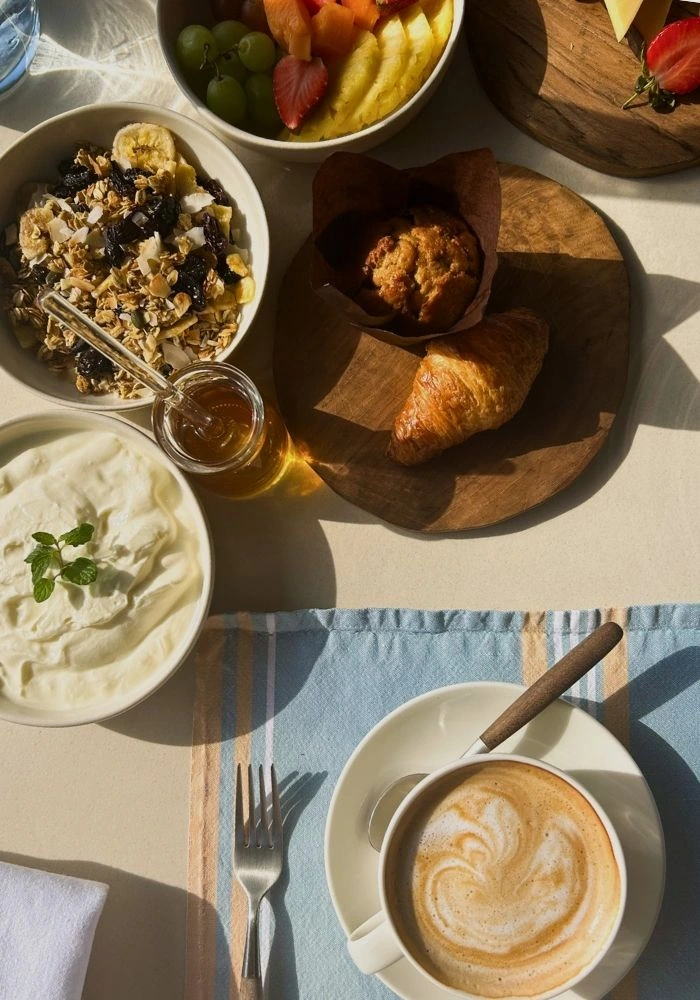 Breakfast spread of coffee, croissants, yoghurt, fruit and cereal at Sala Beach House