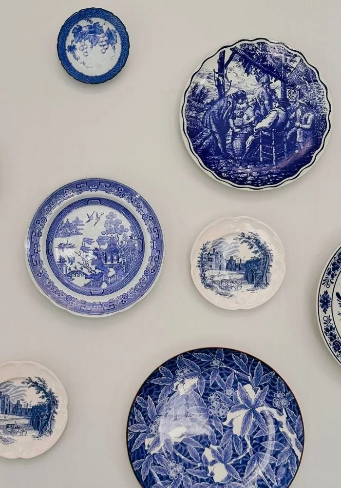 Blue ceramic plates displayed on the dining room wall at River Manor Boutique Hotel