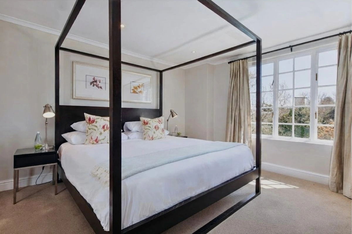 Four-poster bed bedroom at River Manor Boutique Hotel with a treetop view, Stellenbosch