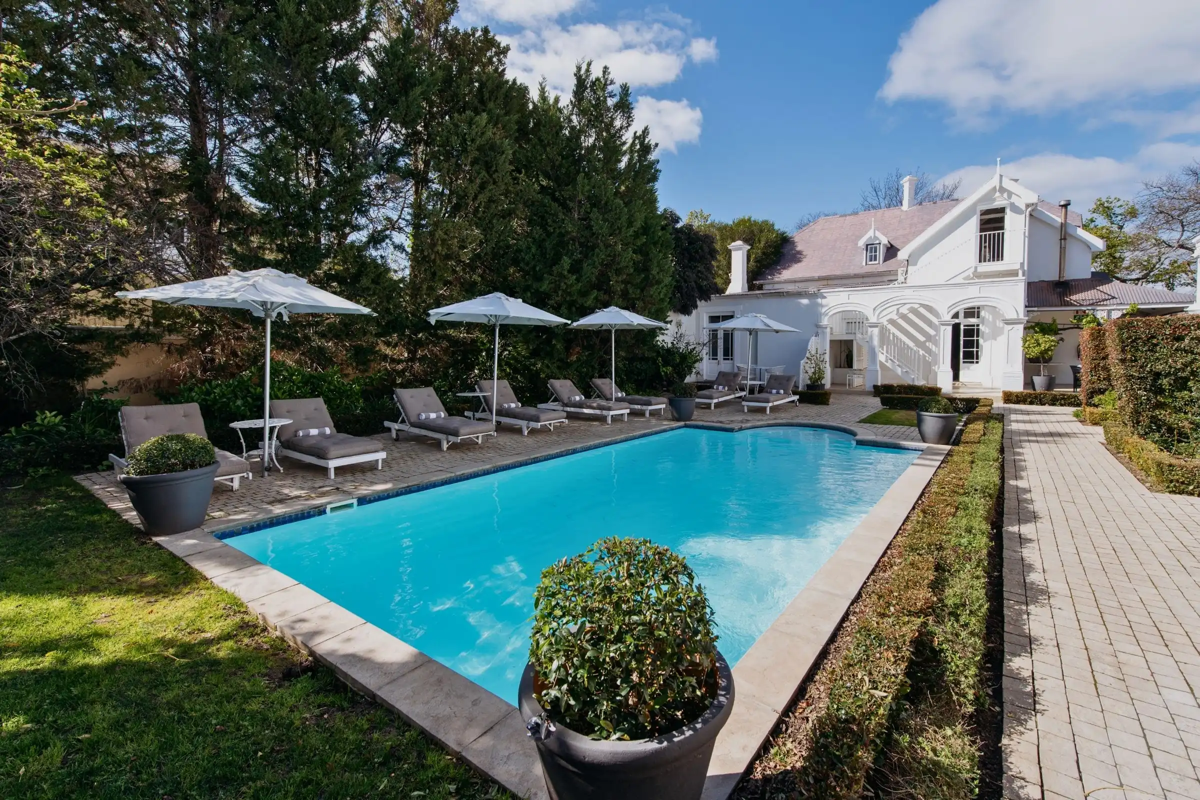 River Manor Boutique Hotel's heritage building, pool and garden loungers in Stellenbosch