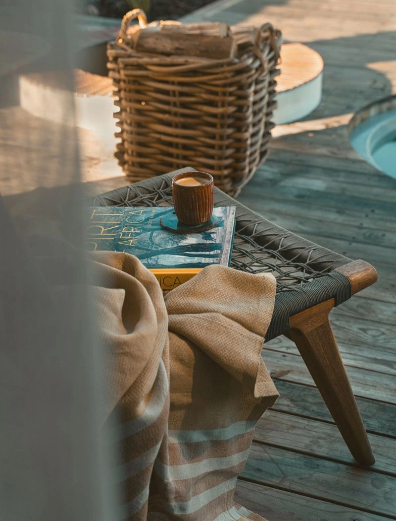Mungo throw draped over a chair beside a handmade pottery coffee cup at De Wildeveldt guest farm near Darling