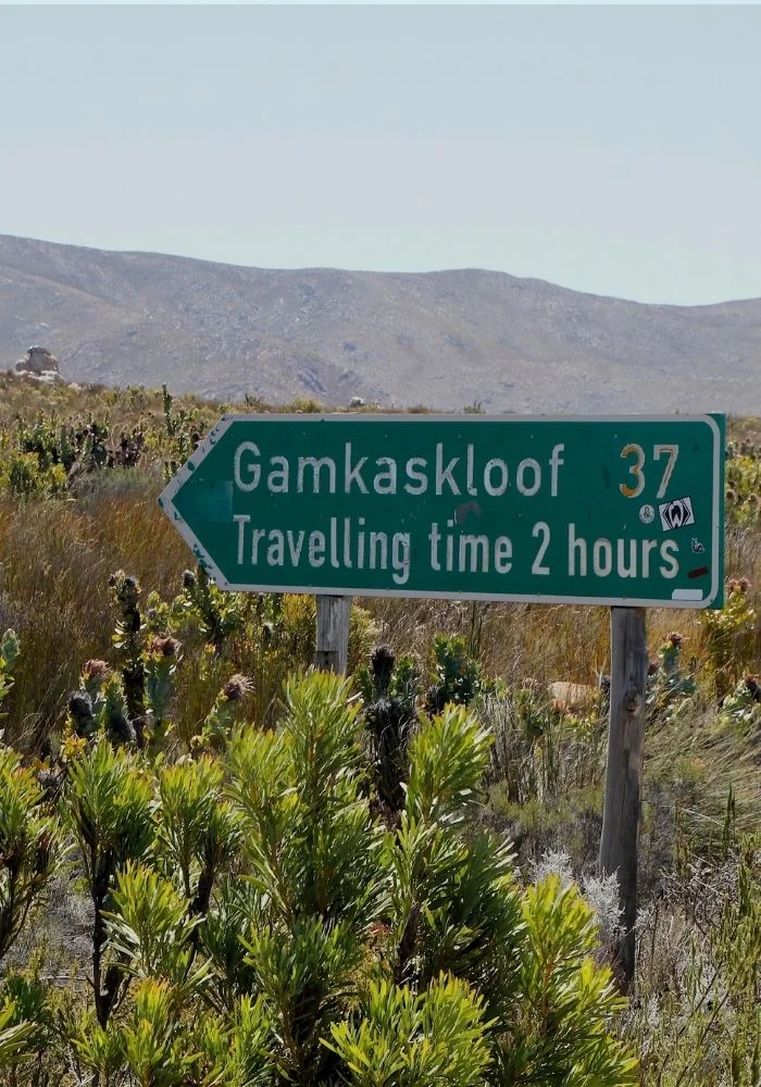 Road sign at the start of the Gamkaskloof road off the Swartberg Pass, showing 37km and a travel time of two hours.